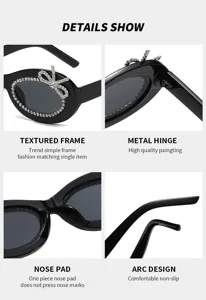 Detailansicht schwarzer ovaler Sonnenbrille mit Strass-Schleife, Scharnier und Nasenpolster.