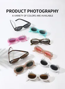 Detailansicht der farbigen ovalen Sonnenbrille mit funkelnden Strass-Schleifen, trendig.