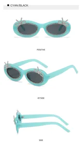 Türkisblaue ovale Sonnenbrille mit funkelnden Strass-Schleifen und stilvollem Randdekor.