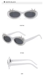 Weiße ovale Strass-Sonnenbrille Detailansicht mit Schleifenverzierung aus Winkeln.