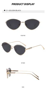 Gafas de sol cat-eye de metal con lentes negras y montura dorada elegante en detalle.