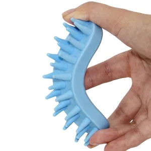 Silicone pet bath brush and dog massage comb with flexible curved design for easy grooming.