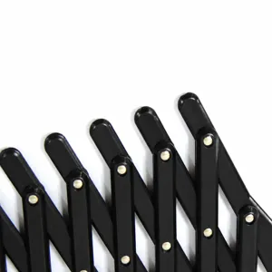 Black expandable pet fence safety gate for car window and home use, adjustable grid barrier.