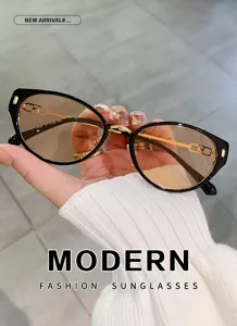 Detailed shot of trendy cat-eye sunglasses with gradient lenses and stylish metal chain temples.