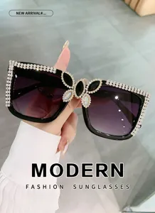 Fashion large frame rhinestone sunglasses with gradient lenses and elegant butterfly decor.