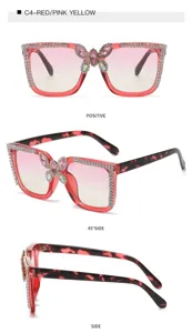 Close-up details of stylish oversized rhinestone sunglasses with butterfly accent and gradient lenses.
