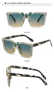 Detailed view of large frame rhinestone sunglasses with green butterfly bridge design.