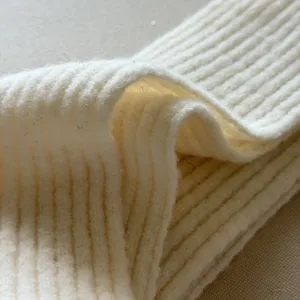 Close-up view of a soft ribbed knit winter scarf, showing cozy wool blend texture and fabric detail.