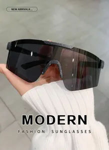 Oversized shield sunglasses detail, modern fashion sun eyewear with splatter frame design.