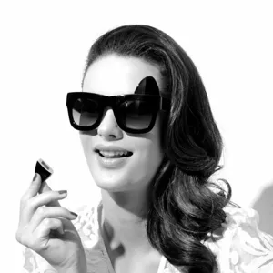 Detail shot of black butterfly sunglasses featuring a unique detachable cat ear accessory.