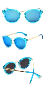 Detail view of stylish blue mirrored sunglasses with gold metal temples and transparent blue frame.