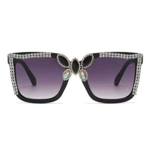 Fashion large frame rhinestone sunglasses with gradient lenses and butterfly decor.