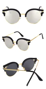 Close-up detail of retro half-frame sunglasses with gold metal frame and black brow line.