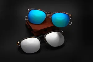 Detailed view of fashion sunglasses with colorful mirrored lenses and metal cutout frames.
