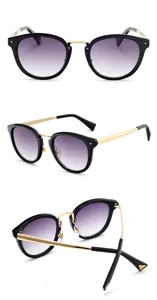 Detailed view of fashion sunglasses featuring black round frames, gold temples and purple lenses.