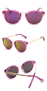 Detailed view of stylish purple frame sunglasses with gold temples and reflective lenses.