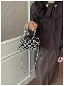 Chic silver beaded hollow crossbody bag detail view, stylish women's mini handbag accessory.