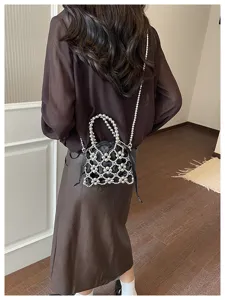 Chic black beaded mesh crossbody bag detail, stylish metallic pearl design and delicate strap.