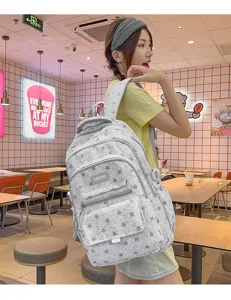 Detailed view of large capacity star pattern backpack worn by a girl in a modern cafe setting