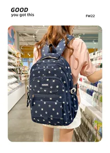 Detailed view of a navy blue backpack with star pattern worn by a model in a retail shop