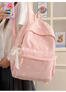 Vue détaillée du sac à dos scolaire à carreaux roses avec nœud en dentelle