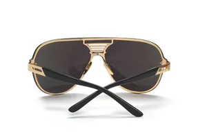 Close-up detail of luxury oversized metal shield sunglasses with bold one-piece black lenses.