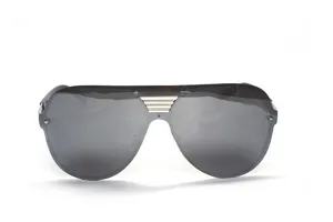 Close-up detail of trendy oversized shield sunglasses featuring a stylish metallic bridge accent.