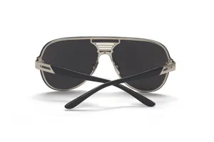 Detailed shot of trendy oversized metal frame sunglasses with one-piece dark lenses and stylish bridge.