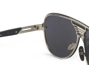 Close-up detail of stylish metal frame sunglasses temple hinge and dark lens design.