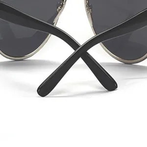 Detailed shot of classic aviator sunglasses featuring dark lenses and black temple arms.