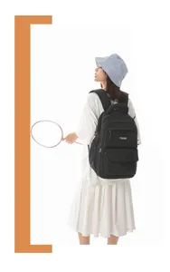 Detailed view of black Japanese academy style backpack with letter embroidery on student model