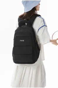 Back view of a model wearing a black large-capacity school backpack with embroidery