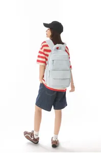 Model wearing a light blue large capacity school backpack in Japanese academy style