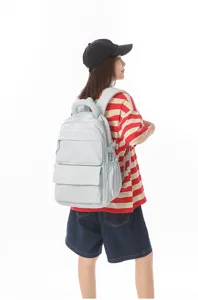 Back view of model carrying a light blue high-capacity Japanese style student backpack