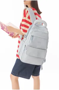 Detailed view of the light blue Japanese style school backpack with embroidered logo