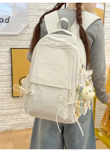 Vue arrière d'un sac à dos blanc avec broderie 'Have a good day' et nœuds décoratifs