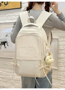Vue de dos d'un sac à dos d'école blanc minimaliste avec broderie 'Have a good day'