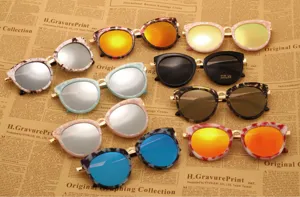 Vue détaillée de lunettes de soleil papillon tendance aux montures marbrées et verres miroirs.