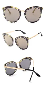 Vue détaillée lunettes soleil femme papillon monture pierre fleurie branches métal doré.