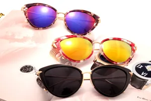 Fashion cat-eye sunglasses with colorful reflective and black lenses for outdoor travel.