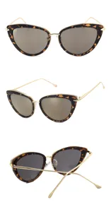 Cat-eye sunglasses featuring tortoise shell frames and gold metal temples. Stylish eyewear.