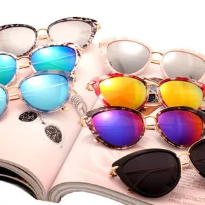 Fashion cat-eye sunglasses with colorful reflective lenses, stylish metal frame for travel and street wear.
