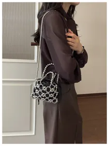 Chic metallic beaded crossbody bag with a sleek black inner pouch and stylish silver chain.