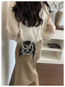 Chic metallic beaded crossbody bag detail, elegant hollow design with shoulder chain.