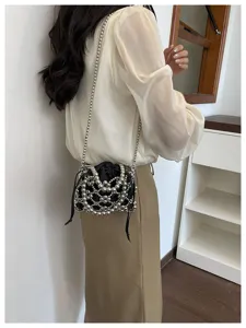 Chic beaded crossbody bag featuring black satin inner pouch and silver metallic mesh design.