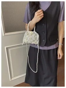 Elegant pearl beaded mini handbag with drawstring lining and stylish cross-body chain.