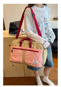 Model wearing a stylish pink and khaki large capacity travel bag in a casual lifestyle setting.