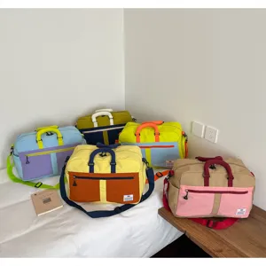 Large capacity color-blocking travel bags with adjustable shoulder straps and handles.