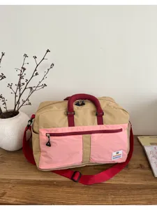 Large capacity color-block outdoor travel bag with red handles and shoulder strap