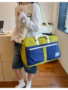 Large capacity color-block travel bag shown on shoulder for stylish outdoor travel